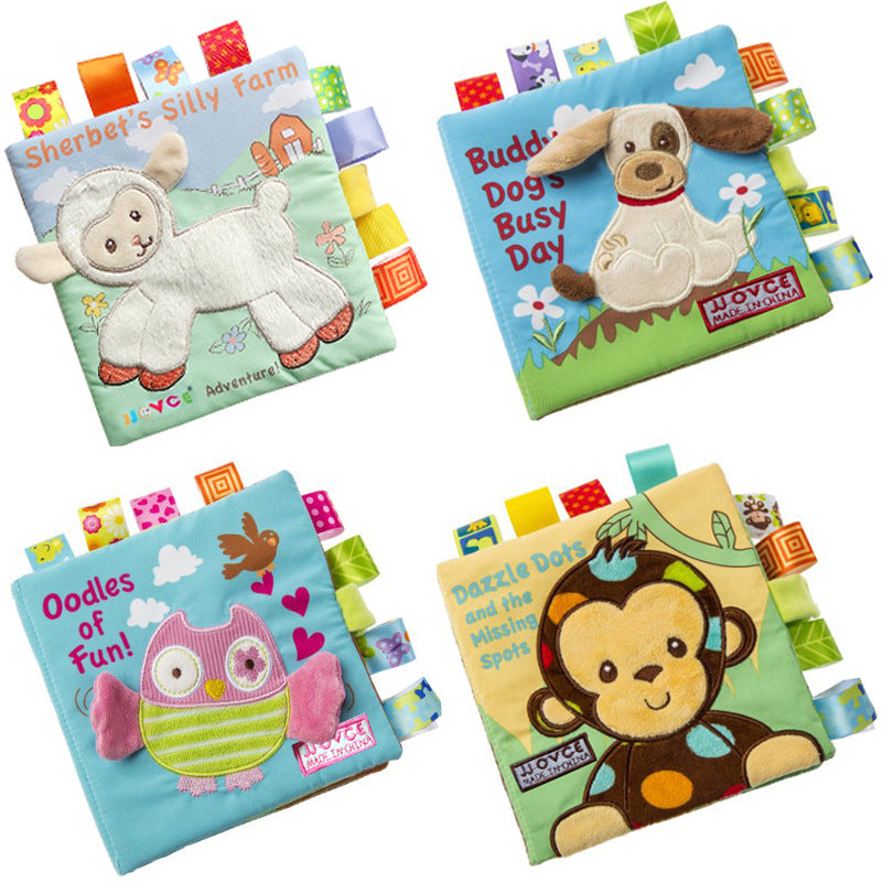 Collection of four soft baby books with tactile tags, featuring &